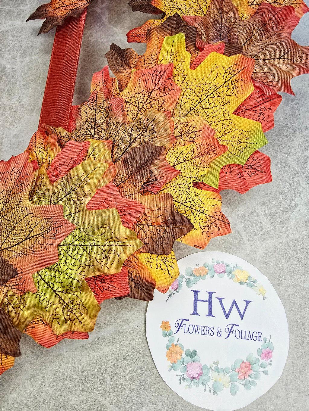 Warmth of Autumn Wreath - close up of autumn leaves and mandarin ribbon detail