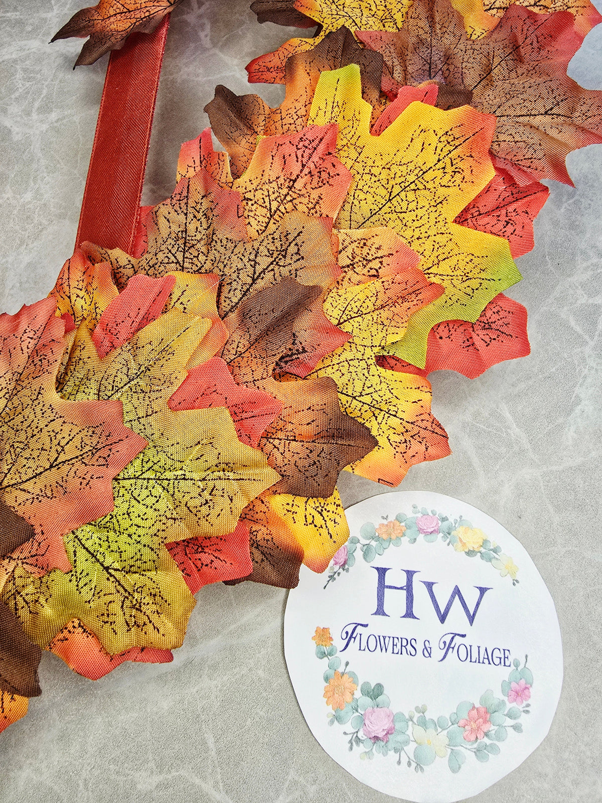 Warmth of Autumn Wreath - close up of autumn leaves and mandarin ribbon detail