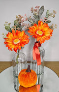 Autumn Gerbera Vase Set – two clear glass Zambia vases with orange gerberas and velvet pumpkin