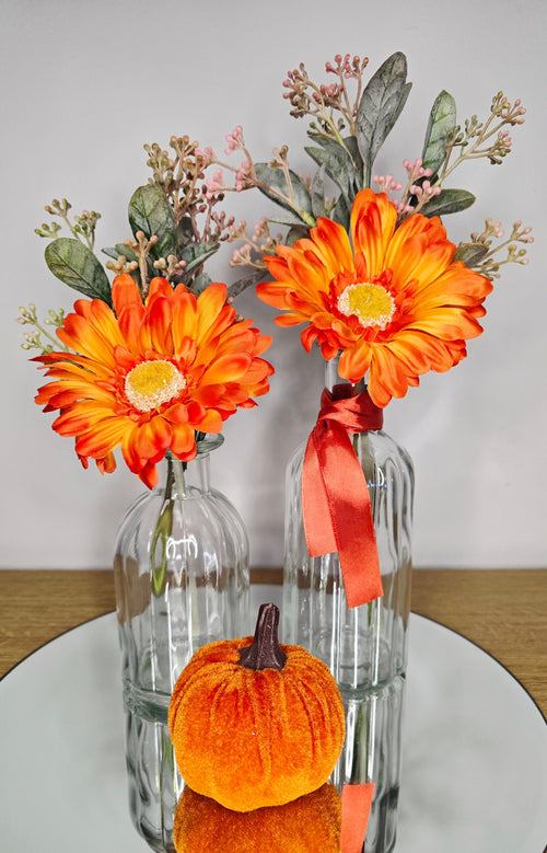 Autumn Gerbera Vase Set – two clear glass Zambia vases with orange gerberas and velvet pumpkin
