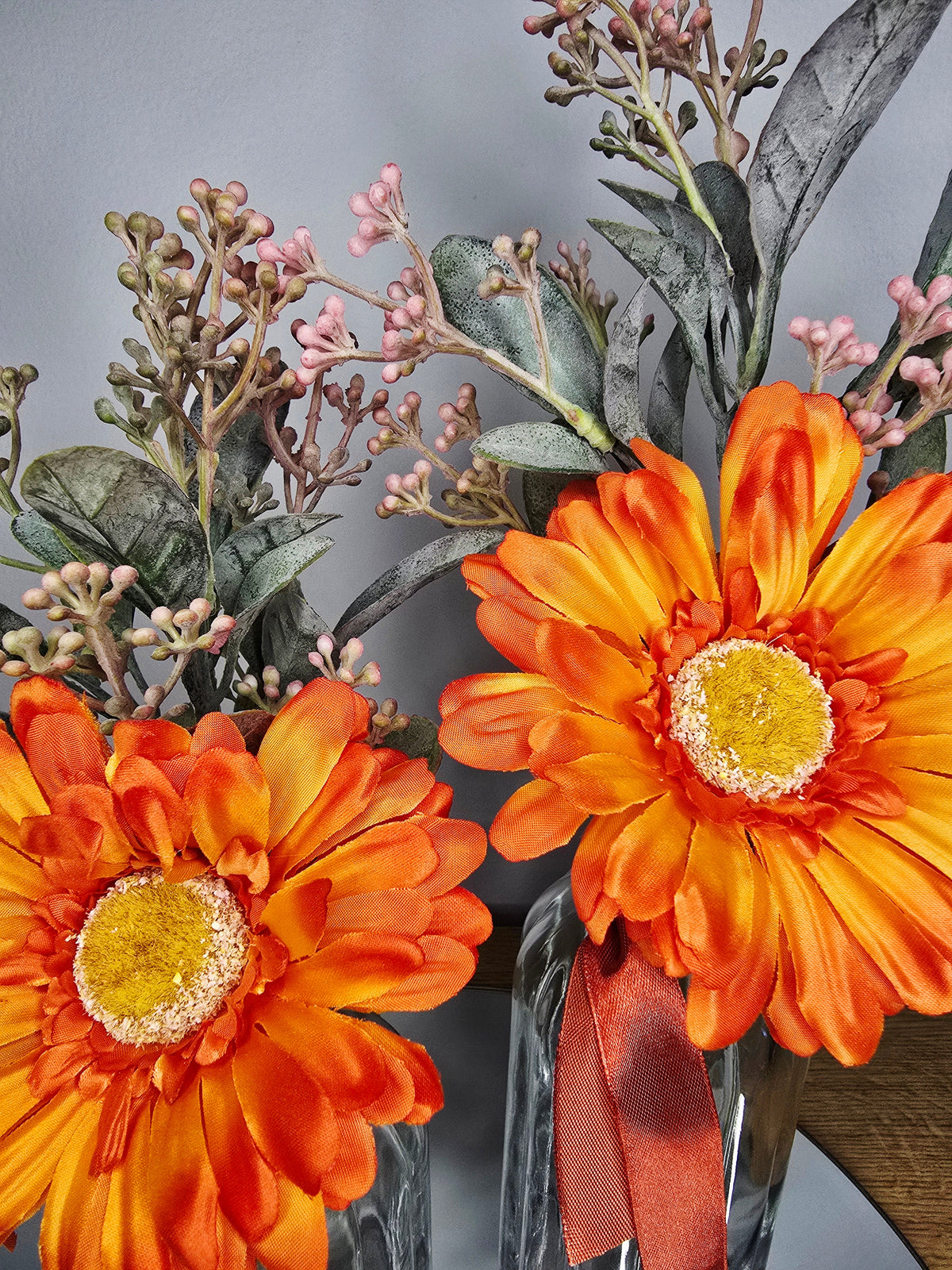 Autumn Gerbera Vase Set – close up of orange gerbera blooms with mandarin ribbon